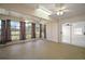 Bright sunroom featuring large windows, ceiling fans, and sliding glass doors to the exterior at 705 Grand Vista Trl, Leesburg, FL 34748