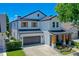 Beautiful two-story home with a dark gray garage door, wood-accented porch columns, and manicured landscaping at 722 Barefoot Bay Loop, Clermont, FL 34736