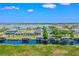 Expansive aerial view showcasing the community's waterfront homes and lake access at 722 Barefoot Bay Loop, Groveland, FL 34736