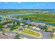 Aerial view of the neighborhood featuring well-maintained lawns and picturesque waterfront access at 722 Barefoot Bay Loop, Groveland, FL 34736