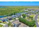 An aerial view of a neighborhood with waterfront homes and a lake in the background at 722 Barefoot Bay Loop, Groveland, FL 34736