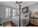Comfortable bedroom showcasing a four-poster bed, ceiling fan and plantation shutters at 722 Barefoot Bay Loop, Groveland, FL 34736