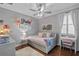 Charming bedroom with personalized decor, a cozy daybed, and soft lighting at 722 Barefoot Bay Loop, Groveland, FL 34736