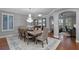 Formal dining room with wood floors, an elegant chandelier, and ample seating for Gathering and guests at 722 Barefoot Bay Loop, Groveland, FL 34736