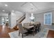 Bright dining room with a chandelier, dining table and chairs, as well as hardwood flooring at 722 Barefoot Bay Loop, Groveland, FL 34736