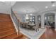 Elegant dining room showcasing a chandelier, an elegant staircase, and refined decor at 722 Barefoot Bay Loop, Groveland, FL 34736