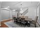 Formal dining room with a crystal chandelier, wood floors, and an elegant staircase accent at 722 Barefoot Bay Loop, Groveland, FL 34736