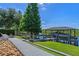 Scenic waterfront property with a private boat dock featuring a covered boat lift and a charming walkway at 722 Barefoot Bay Loop, Groveland, FL 34736