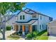 Beautiful two-story home featuring a cozy porch and well-maintained landscaping at 722 Barefoot Bay Loop, Groveland, FL 34736