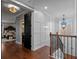 Beautiful hallway with rich hardwood floors and eye-catching, modern accents throughout the home at 722 Barefoot Bay Loop, Groveland, FL 34736