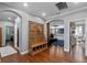 Hallway with a bench, arched doorways, and hardwood floors at 722 Barefoot Bay Loop, Groveland, FL 34736