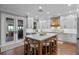 Open kitchen with an island, white cabinetry, and stainless steel appliances at 722 Barefoot Bay Loop, Groveland, FL 34736