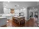 Spacious kitchen with white cabinetry, an island with seating, and stainless steel appliances at 722 Barefoot Bay Loop, Groveland, FL 34736