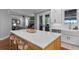 Open kitchen with a large island, modern white cabinets, and seamless flow to the living area at 722 Barefoot Bay Loop, Groveland, FL 34736