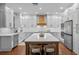 Bright, spacious kitchen with an island, white cabinets, and stainless steel appliances at 722 Barefoot Bay Loop, Groveland, FL 34736