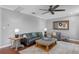 Cozy living room with plush seating, stylish decor, and ample natural light at 722 Barefoot Bay Loop, Groveland, FL 34736