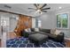 Spacious living room featuring a large sectional sofa and a sliding barn door at 722 Barefoot Bay Loop, Groveland, FL 34736