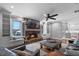 Bright living room features a stone fireplace, built-in shelves, hardwood floors, and lake views at 722 Barefoot Bay Loop, Groveland, FL 34736