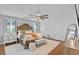 Spacious main bedroom with a large bed, chandelier, and hardwood floors at 722 Barefoot Bay Loop, Groveland, FL 34736