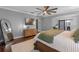 Main bedroom featuring hardwood floors, a wooden bed frame, and soft lighting at 722 Barefoot Bay Loop, Groveland, FL 34736