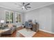 Comfortable home office with neutral paint, hardwood floors, modern fan, and abundant natural light at 722 Barefoot Bay Loop, Groveland, FL 34736