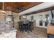 Elegant outdoor kitchen with granite countertops, stainless steel appliances, and a dining area at 722 Barefoot Bay Loop, Groveland, FL 34736