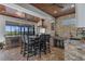 Well-equipped outdoor kitchen with grill, sink, seating and stone accents perfect for entertaining guests at 722 Barefoot Bay Loop, Groveland, FL 34736