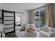 Bright sitting room with white furniture, barn door, and balcony with scenic views at 722 Barefoot Bay Loop, Groveland, FL 34736