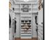 Organized walk-in closet featuring custom shelving and ample space for clothing and accessories at 722 Barefoot Bay Loop, Groveland, FL 34736