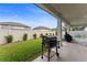Spacious covered patio with grill, overlooking the green fenced backyard at 743 Brooks Field Drive Dr, Winter Garden, FL 34787