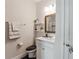 Bathroom with a white vanity, a wood framed mirror, and shiplap accent wall at 743 Brooks Field Drive Dr, Winter Garden, FL 34787