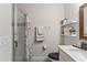 Bathroom featuring a white vanity, a wood framed mirror, a walk-in shower, and shiplap accent wall at 743 Brooks Field Drive Dr, Winter Garden, FL 34787
