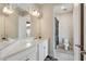Bright bathroom with double vanity, white cabinets, and a view into the shower room at 743 Brooks Field Drive Dr, Winter Garden, FL 34787