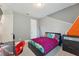 Stylish bedroom with a modern bed, geometrically painted accent wall, and gray carpet at 743 Brooks Field Drive Dr, Winter Garden, FL 34787