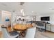 Open dining area with wood table and upholstered chairs near a modern kitchen and living room at 743 Brooks Field Drive Dr, Winter Garden, FL 34787