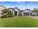 Charming single-story home boasting a lush green lawn, brick driveway, and a convenient two-car garage at 743 Brooks Field Drive Dr, Winter Garden, FL 34787