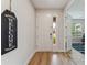 Bright foyer showcasing a modern front door, elegant wood flooring, and a view into an office space at 743 Brooks Field Drive Dr, Winter Garden, FL 34787
