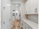 Hallway with white cabinets and appliances leading to the kitchen at 743 Brooks Field Drive Dr, Winter Garden, FL 34787
