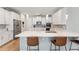 Stylish kitchen with an island, white cabinets, stainless steel appliances, and barstool seating at 743 Brooks Field Drive Dr, Winter Garden, FL 34787