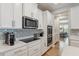 Kitchen with white cabinets, stainless steel appliances, and modern backsplash at 743 Brooks Field Drive Dr, Winter Garden, FL 34787