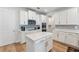 Bright kitchen featuring an island, white cabinetry, and stainless steel appliances at 743 Brooks Field Drive Dr, Winter Garden, FL 34787