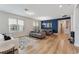 Bright living room with modern furnishings, wood flooring, and a dining area with stylish decor at 743 Brooks Field Drive Dr, Winter Garden, FL 34787