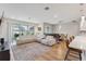 Bright, open-plan living space featuring a sectional sofa, wood floors, and sliding glass doors to the backyard at 743 Brooks Field Drive Dr, Winter Garden, FL 34787