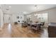 Open-concept living space with wood flooring, comfortable seating, a dining area, and ample natural light at 743 Brooks Field Drive Dr, Winter Garden, FL 34787
