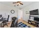 Spacious office with a ceiling fan, wood floors, and a television mounted on the wall at 743 Brooks Field Drive Dr, Winter Garden, FL 34787