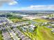 Aerial view of a Primary-planned community with a pool and recreational facilities at 7974 Penrose Pl, Wildwood, FL 34785