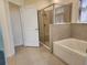 Bathroom featuring a separate shower and tub with tile surround at 7974 Penrose Pl, Wildwood, FL 34785