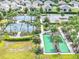 Bocce ball courts surrounded by palm trees, tennis courts, and well-maintained landscaping in a residential area at 7974 Penrose Pl, Wildwood, FL 34785