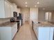 Bright, spacious kitchen featuring granite countertops, stainless appliances and large island at 7974 Penrose Pl, Wildwood, FL 34785