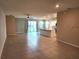 Open-concept living room with tile flooring and sliding glass doors to the backyard at 7974 Penrose Pl, Wildwood, FL 34785